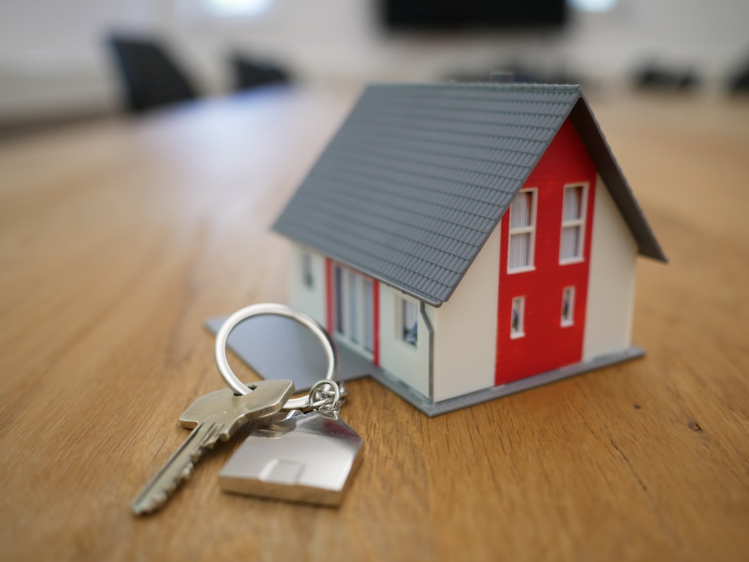 Landlord insurance policy document on a table with a rental property in the background