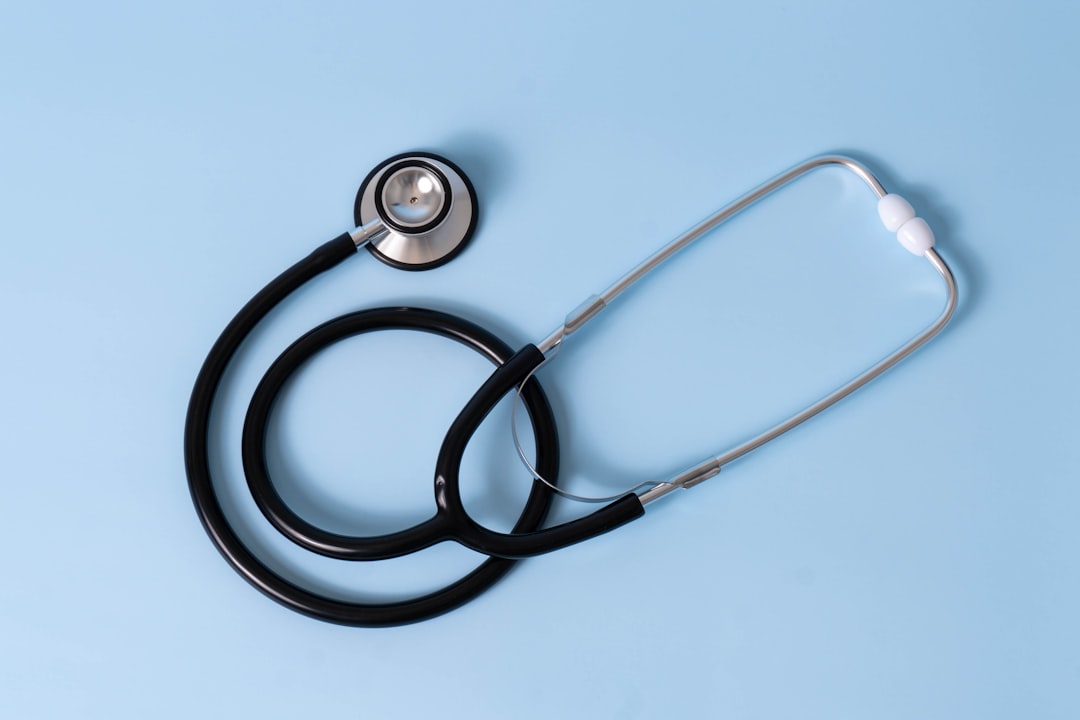 Medicare card and private health insurance card compared side by side on a desk