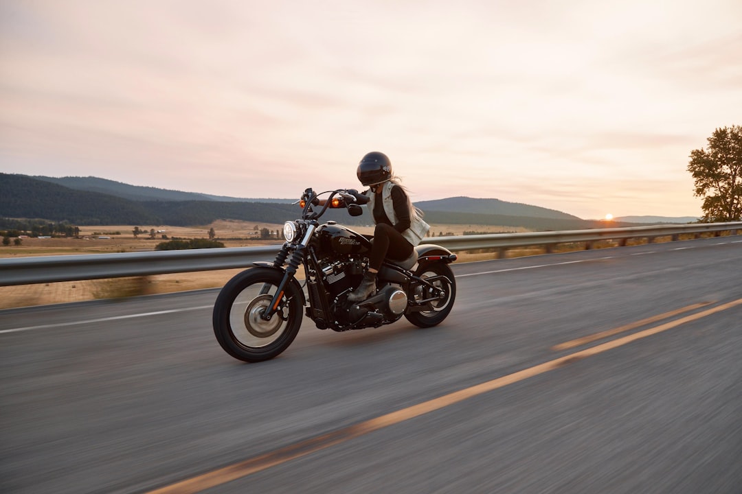 Motorcycle rider on open highway representing the importance of motorcycle insurance
