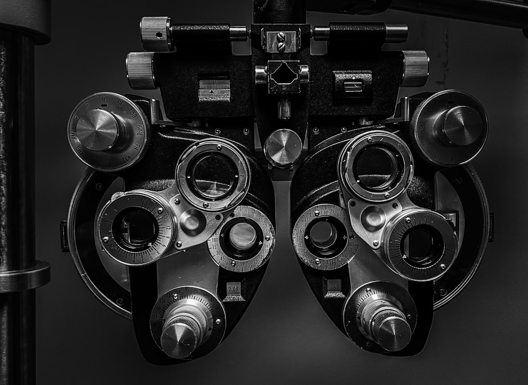 Person comparing vision insurance plans with eyeglasses on desk
