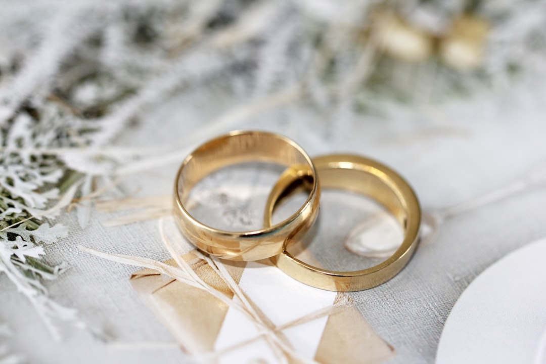 Bride and groom holding hands with wedding ring and insurance policy documents